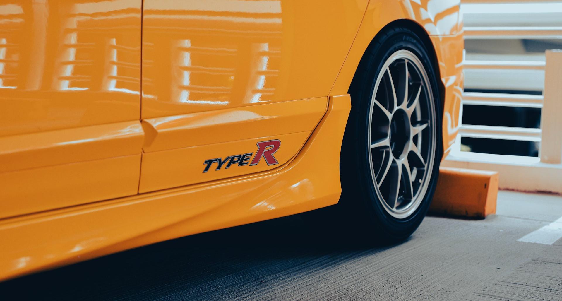 a close up of a yellow sports car